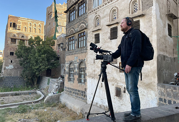 Brent Huffman films a section of old Sana’a in Yemen that was destroyed by bombing.