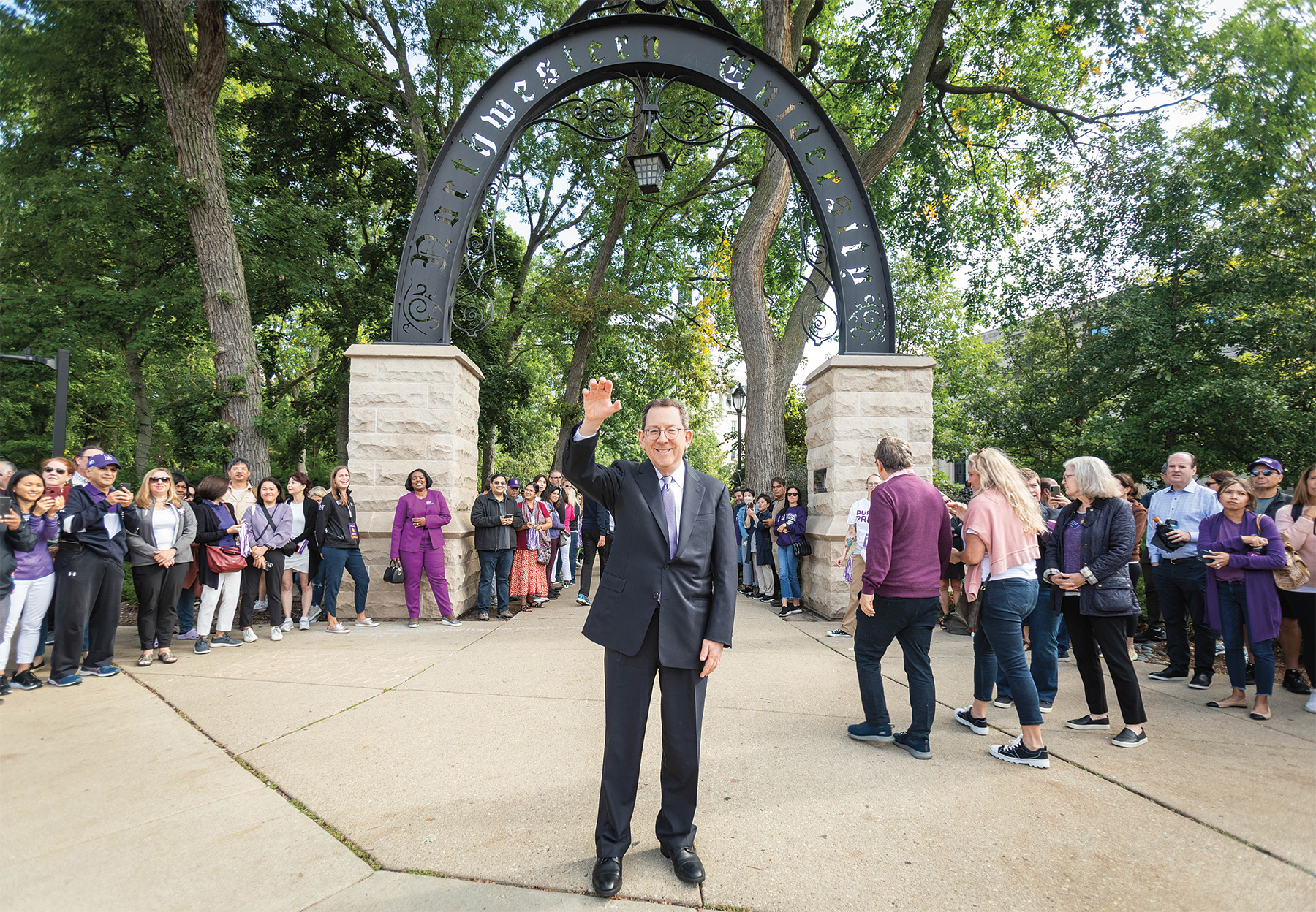 President Schill welcomes students at march through the arch.