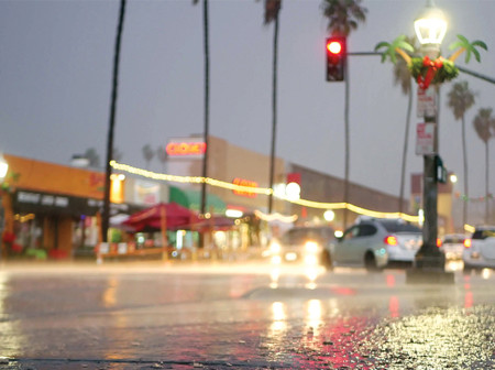 A wet city street at night.