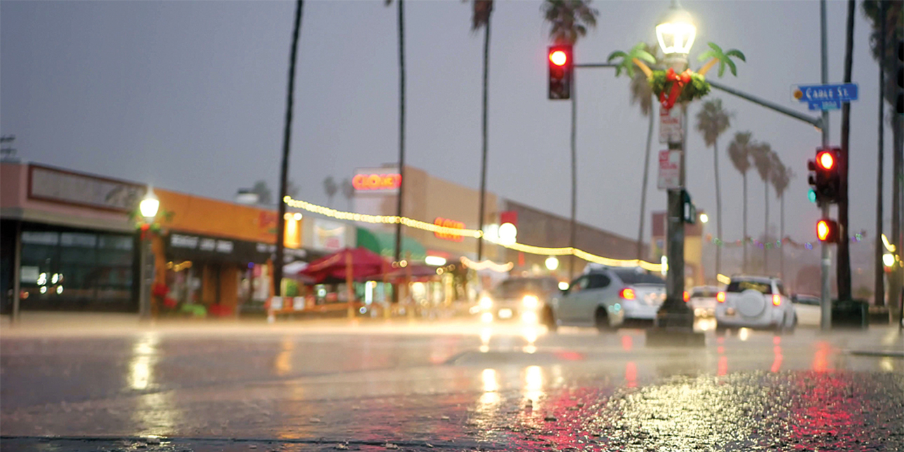 A wet city street at night.
