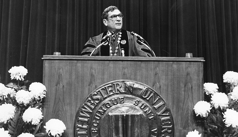 Photo of President Weber standing behind a podium at his inauguration. 