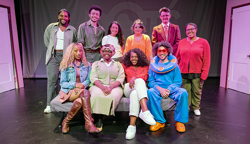 The nine cast members of Dot’s Home Live, in full costume, pose for a picture with executive producer Christina Rosales on the set of the show at the Wirtz Center Chicago.