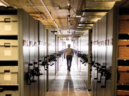 Man walking down a hallway in Northwestern's Archives Vault