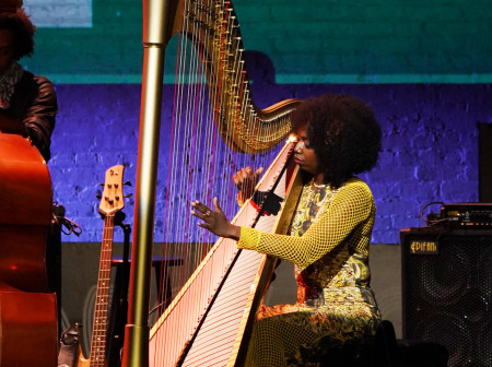 Portrait of grammy-nominated harpist Brandee Younger playing the harp