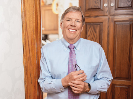 T. Bondurant “Bon” French stands in doorway smiling at the camera.