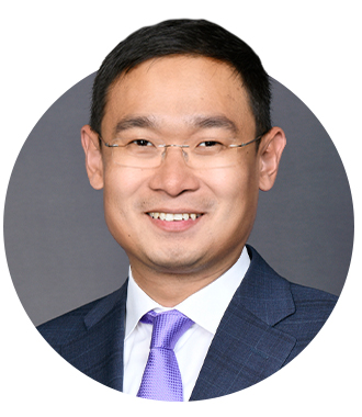 A headshot of Dashun Wang in a dark jacket, purple neck tie and white collared shirt 