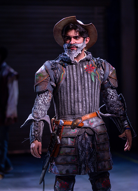 Esteban Ortiz-Villacorta stands on stage, dressed as Don Quixote.