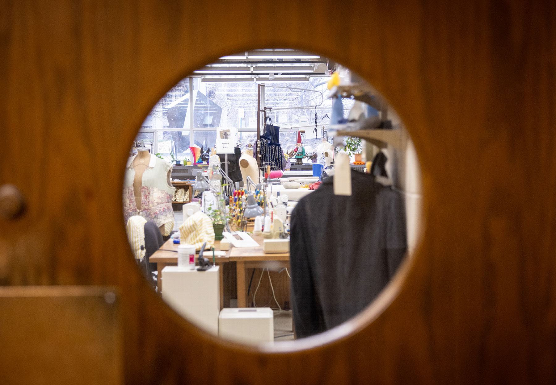 Photo of Northwestern's costume shop shot through a hole in a wooden door.