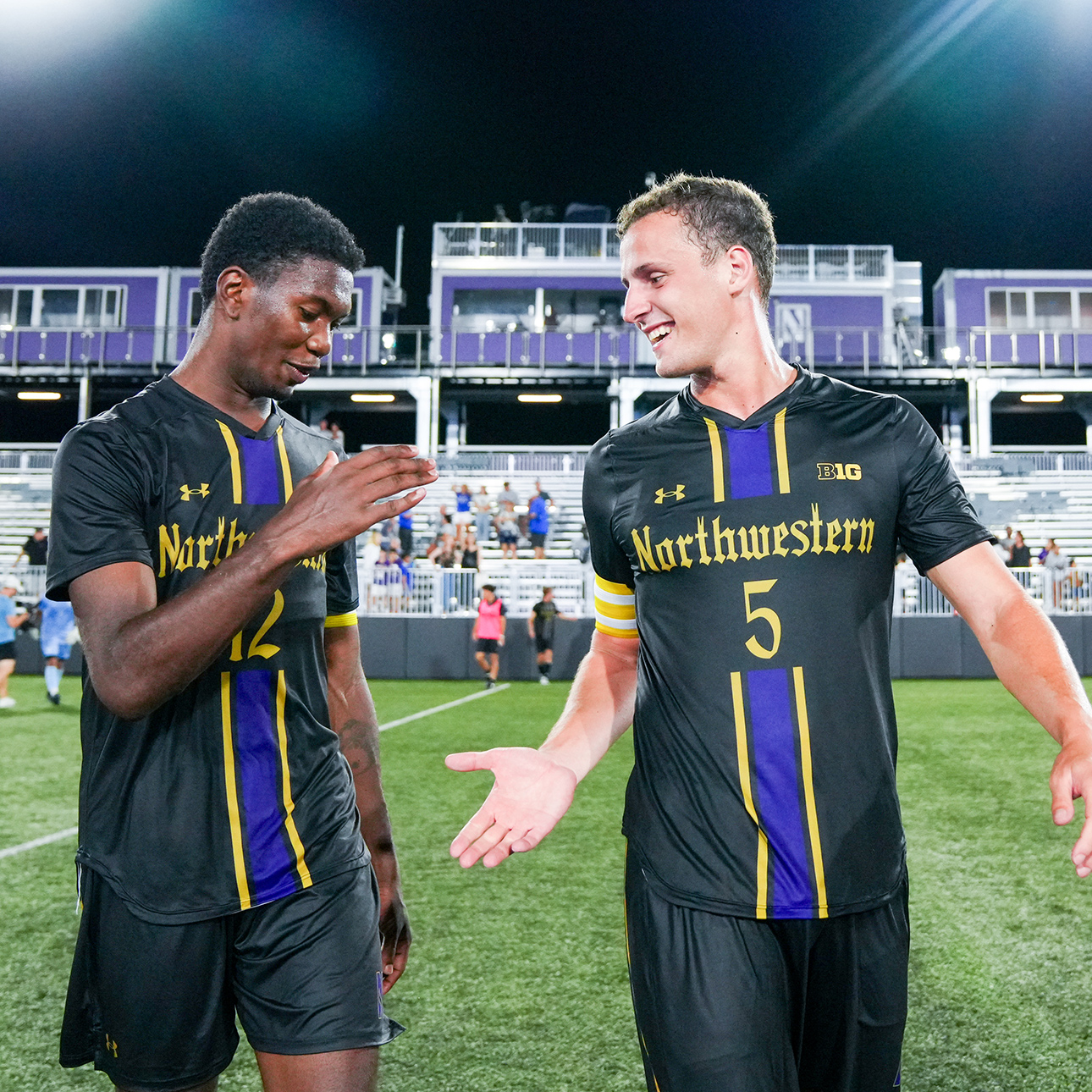 Clad in black Northwestern jerseys, Nigel Prince and Reese Mayer offer each other a low-five. 