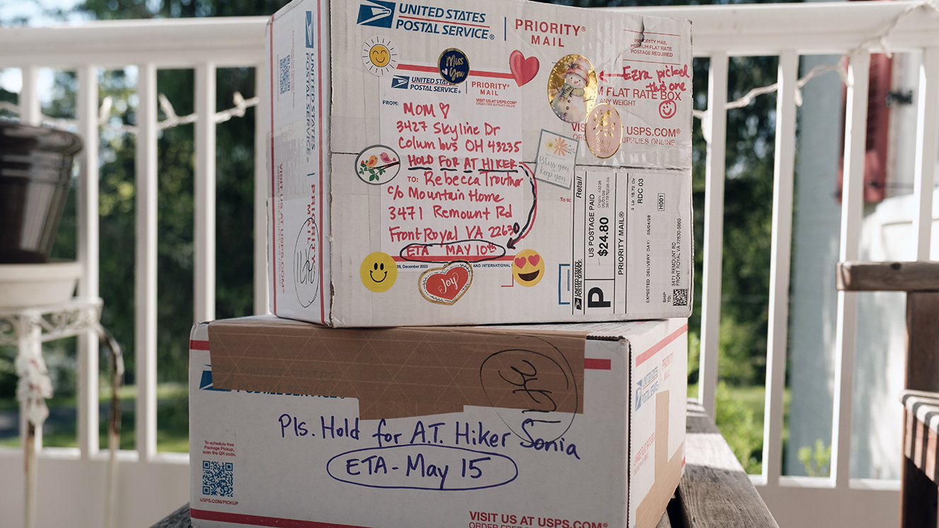 Two packages are stacked on the porch of Mountain Home.