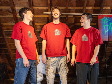 Three men in an attic laugh with each other