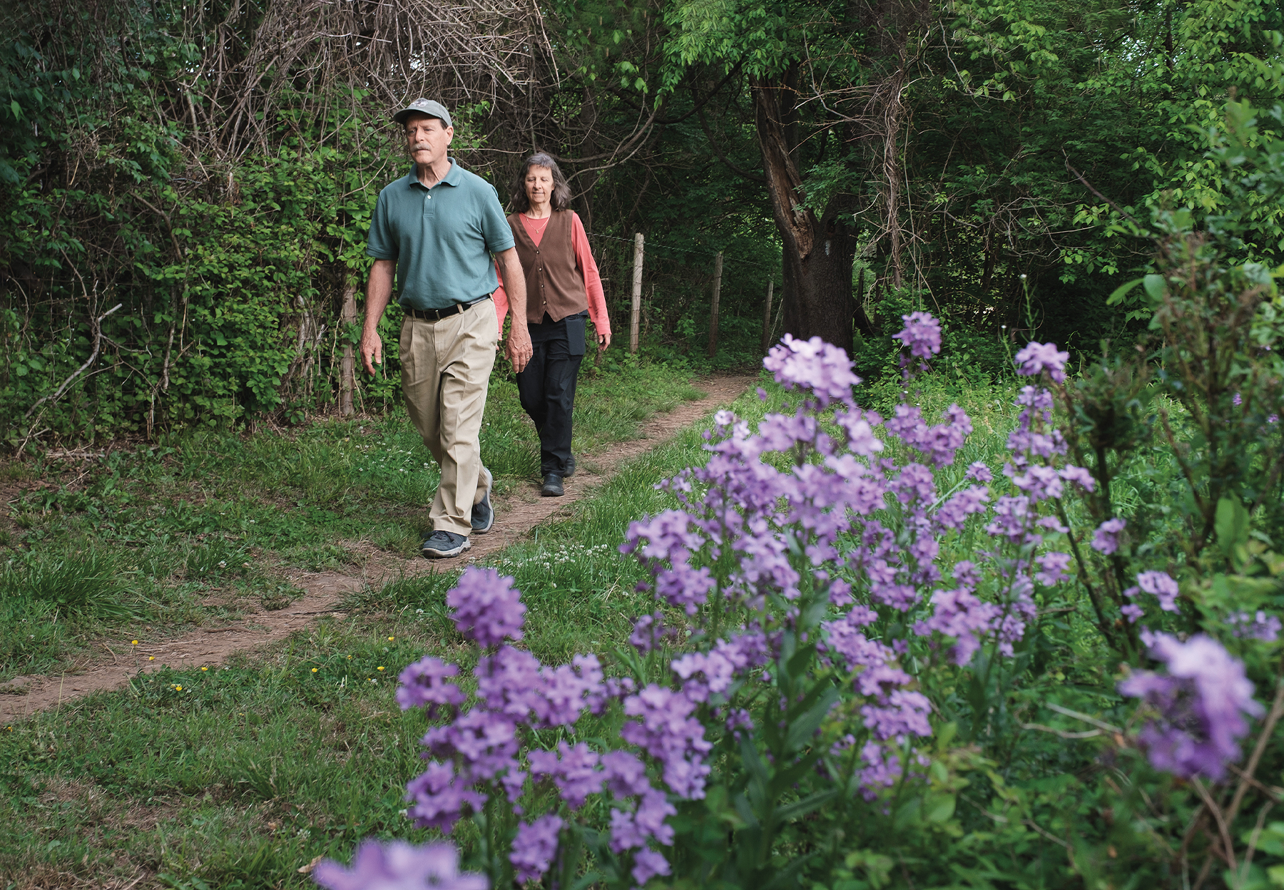Scott and Lisa Jenkins walk along the Appalachian Trail in the woods.