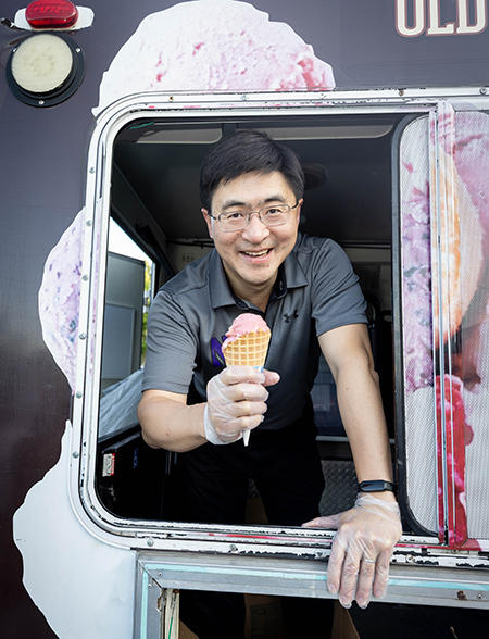 Mung Chiang smiles holding an ice cream cone.