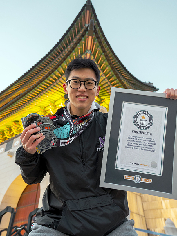 Taeyoung Lee holds up his Guiness World Record in one hand and six Ironman medals in the other.
