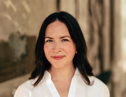 Alexandra Sifferlin smiles for the camera wearing a white blouse